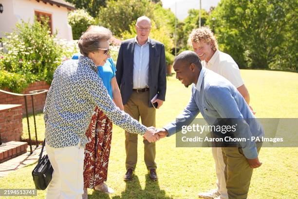 The Princess Royal shakes hands with Bulelani Bashe, head horticulturist at Grootbos Foundation as Leon Kluge, gold winner at the 2024 Chelsea Flower...
