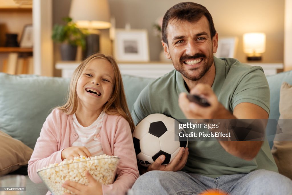 Family Time: Father and Daughter Watching a Live Football Match