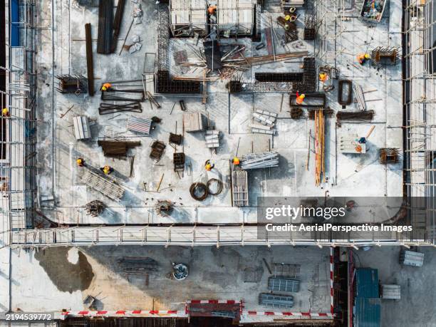 top view of workers working on construction site / hangzhou, zhejiang, china - construction equipment stock pictures, royalty-free photos & images