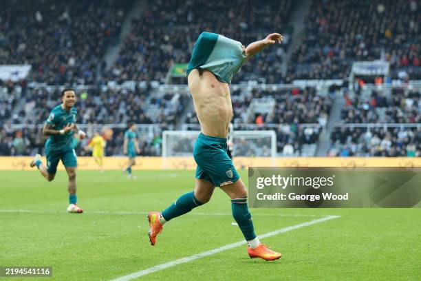 Milos Kerkez of AFC Bournemouth takes his shirt off as he celebrates scoring his team's fourth goal during the Premier League match between Newcastle...
