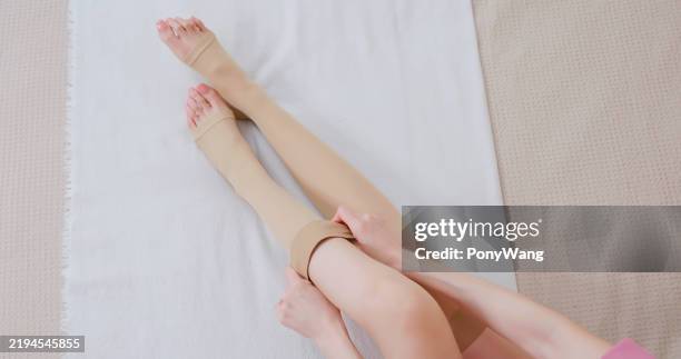 woman is wearing compression socks - damstrumpor bildbanksfoton och bilder