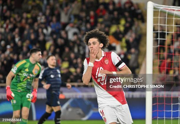 Monaco's French midfielder Maghnes Akliouche reacts after missing a goal during the UEFA Champions League football match between AS Monaco and Aston...
