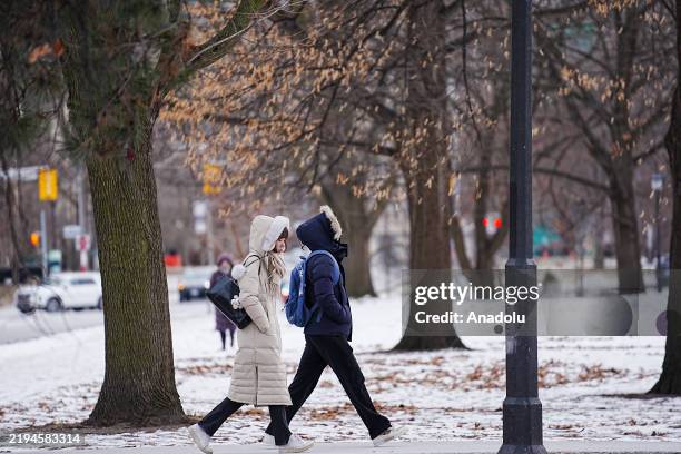 People covering their face and head walk on the street in Toronto, Canada as it is expected to be the coldest day of the winter on January 21, 2025....
