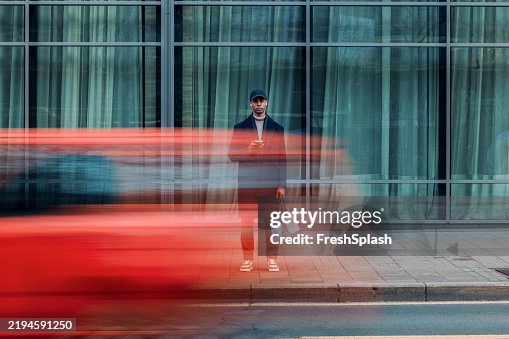 Urban Scene of Man in Motion With a Passing Red Vehicle Urban Scene of Man in Motion With a Passing Red Vehicle