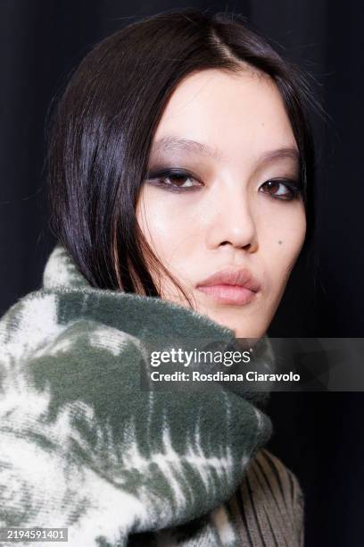 Model poses for photographer in backstage at the JordanLuca fashion show during the Milan Menswear Fall/Winter 2025 - 2026 Fashion Week on January...