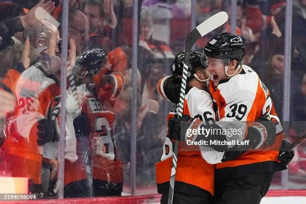 Joel Farabee of the Philadelphia Flyers celebrates with Matvei Michkov after scoring a goal against the Detroit Red Wings in the second period at the...
