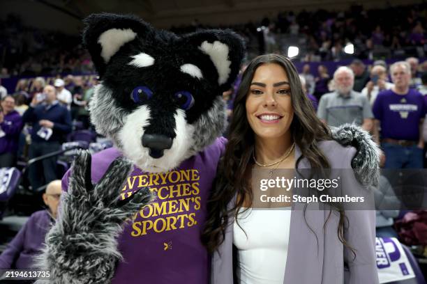 Former Washington Huskies women’s basketball player Kelsey Plum poses with mascot Harry the Husky before her jersey retirement ceremony during...