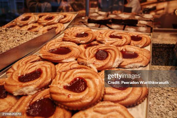 cookies arranged on a metal baking tray. - thumbprint cookie stock pictures, royalty-free photos & images