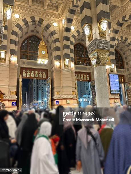 muslim pilgrims praying in the masjid nabawi in medina, saudi arabia - pilgrim stock pictures, royalty-free photos & images