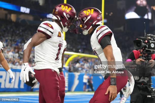 Terry McLaurin of the Washington Commanders celebrates with Jayden Daniels after catching a pass for a touchdown during the second quarter against...