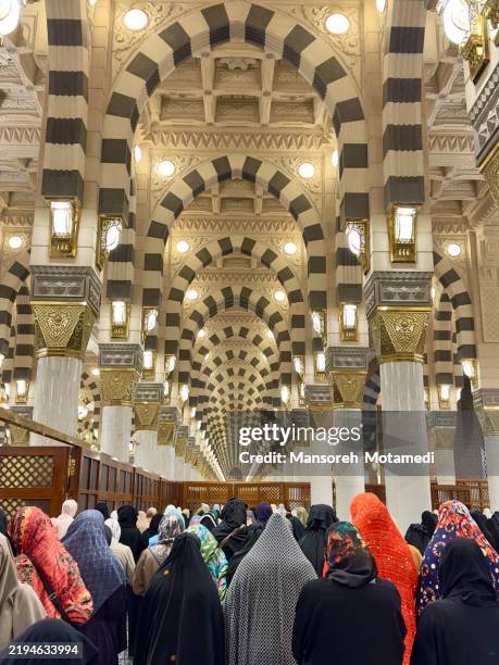 muslim pilgrims praying in the masjid nabawi in medina, saudi arabia - pilgrimage stock pictures, royalty-free photos & images