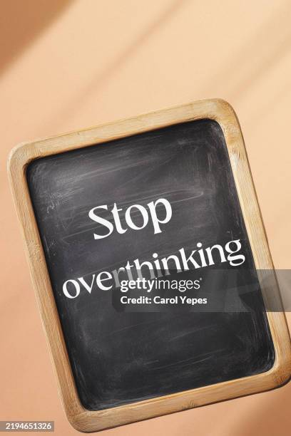 chalkboard with handwritten text stop overthinking, to remind self to stop thinking too much which lead to stress and anxiety - break free from negative thoughts pattern - replay stock pictures, royalty-free photos & images