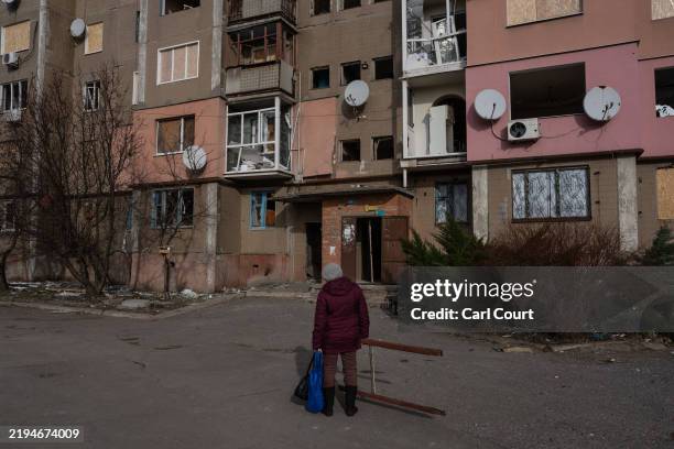 Woman looks up at her apartment block after it was damaged in a Russian attack two days ago, on January 22, 2025 in Kostyantynivka, Ukraine. Ukraine...