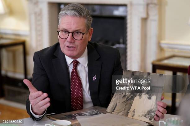 Prime Minister Keir Starmer holds a picture as he attends a reception ahead of Holocaust Memorial Day at Downing Street on January 22, 2025 in...
