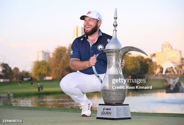 Tyrrell Hatton of England poses with the trophy following victory on day four of the Hero Dubai Desert Classic at Emirates Golf Club on January 19,...
