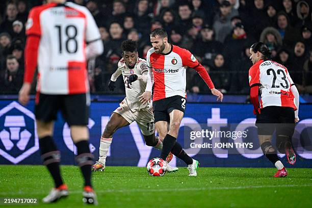 Bayern Munich's French forward Kingsley Coman and Feyenoord's Dutch defender Bart Nieuwkoop fight for the ball during the UEFA Champions League,...