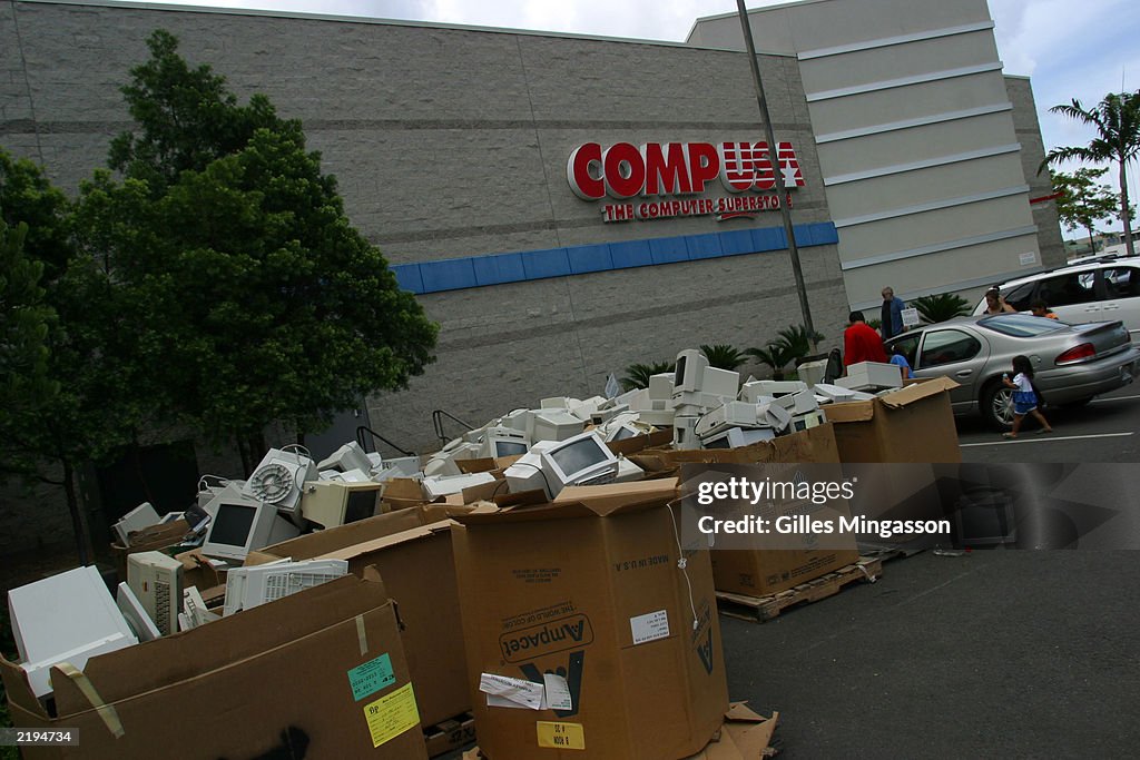 Boxes full of discarded computers lie in front of a CompUSA computer ...