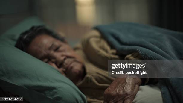 elderly wear a smart watch while sleeping. - better sleep stock pictures, royalty-free photos & images