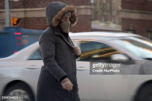 Woman dresses in layered winter clothing while walking in Toronto, Ontario, Canada, on January 22, 2025. A polar vortex descends over much of Canada,...