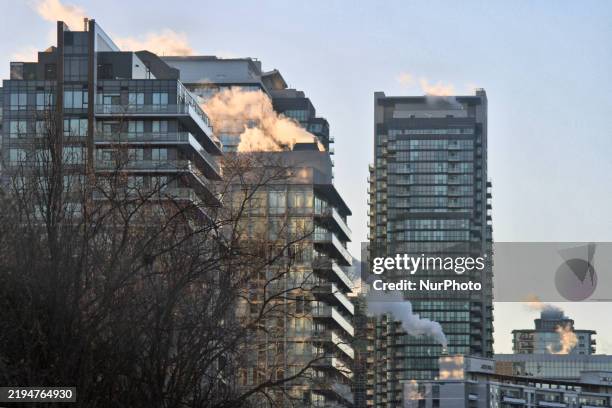 Smoke is seen from buildings in Toronto, Ontario, Canada, on January 22, 2025. A polar vortex descends over much of Canada, bringing arctic air and...