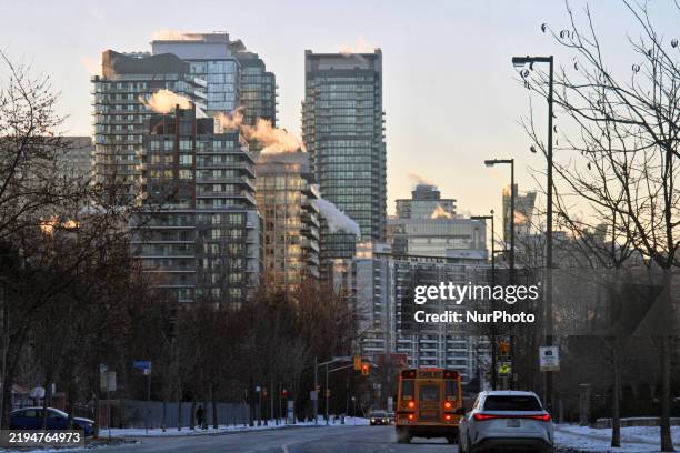 Smoke is seen from buildings in Toronto, Ontario, Canada, on January 22, 2025. A polar vortex descends over much of Canada, bringing arctic air and...