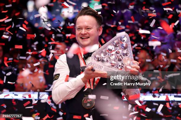 Shaun Murphy of England celebrates with the trophy after winning on day eight of the Johnstone's Paint Masters 2025 at Alexandra Palace on January...