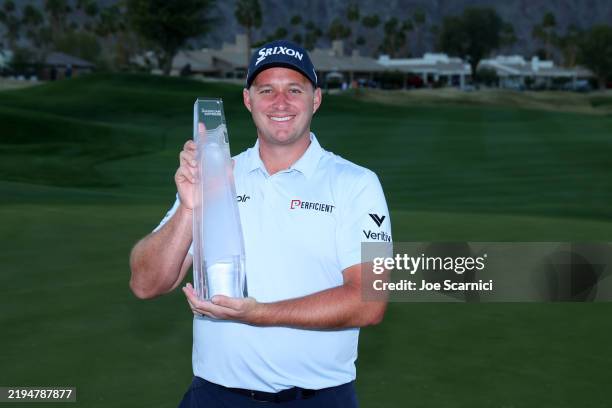 Sepp Straka of Austria poses with the trophy after putting in to win on the 18th green during the final round of The American Express 2025 at Pete...