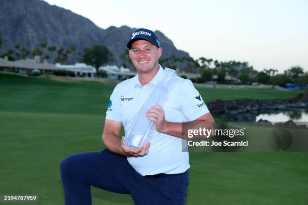 Sepp Straka of Austria poses with the trophy after putting in to win on the 18th green during the final round of The American Express 2025 at Pete...