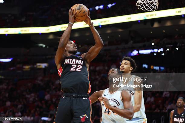 Jimmy Butler of the Miami Heat drives against Harrison Barnes of the San Antonio Spurs during the first quarter of the game at Kaseya Center on...