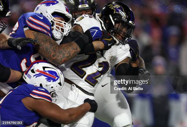 Derrick Henry of the Baltimore Ravens runs the ball against the Buffalo Bills in the third quarter during the AFC Divisional Playoff at Highmark...