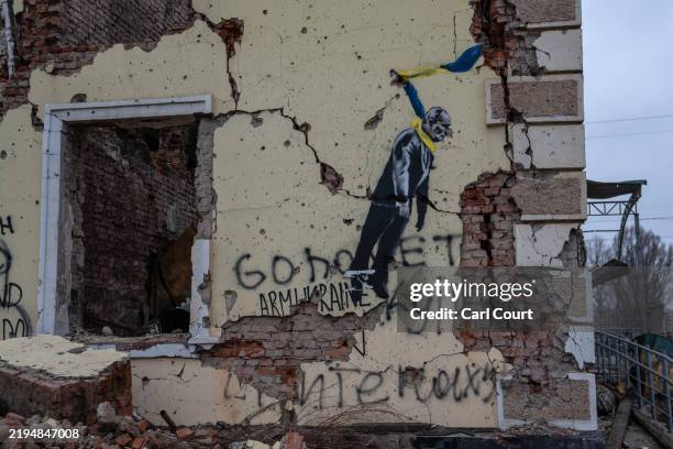 Graffiti depicting Russian leader Vladimir Putin hanging by a Ukrainian flag is pictured on a heavily damaged wall of Kostyantynivka train station...