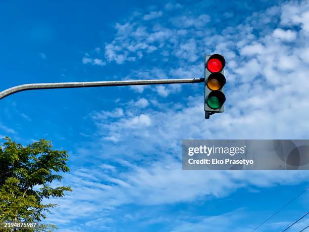 traffic lights against blue sky - traffic light stock pictures, royalty-free photos & images