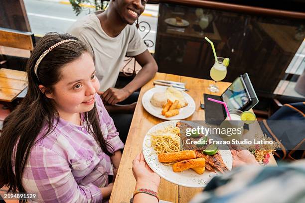 friends talking with waitress on a restaurant - buffalo chicken tenders stock pictures, royalty-free photos & images