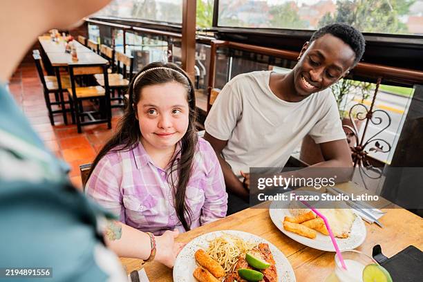 friends talking with waitress on a restaurant - buffalo chicken tenders stock pictures, royalty-free photos & images