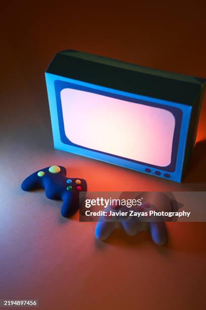 two gamepads placed in front of a vintage tv, ready for a gaming session - home cinema system stock pictures, royalty-free photos & images