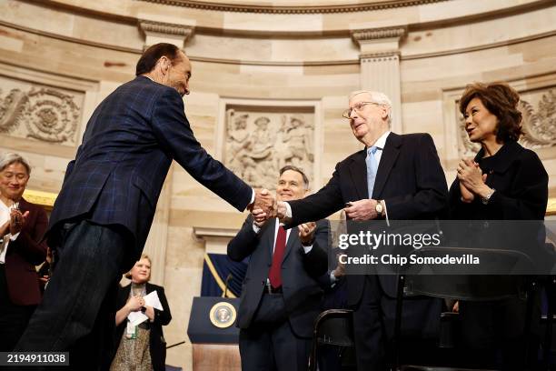 Singer-songwriter Lee Greenwood greets U.S. Sen. Mitch McConnell after performing during the inauguration of U.S. President-elect Donald Trump in the...