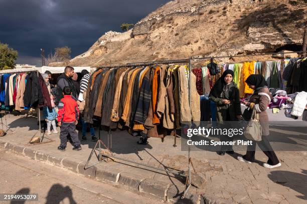 People walk through a market in the city of Homs on January 20, 2025 in Homs, Syria. Homs, the country’s third-largest city, has a mixed population...