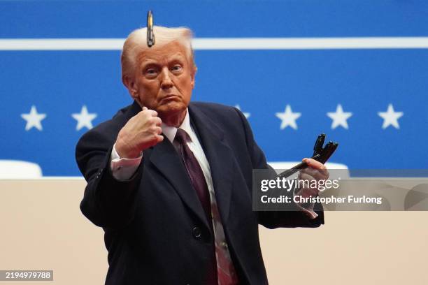 President Donald Trump throws a pen after signing executive orders during an indoor inauguration parade at Capital One Arena on January 20, 2025 in...