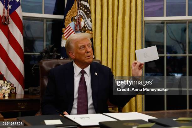President Donald Trump signs executive orders in the Oval Office on January 20, 2025 in Washington, DC. Trump takes office for his second term as the...