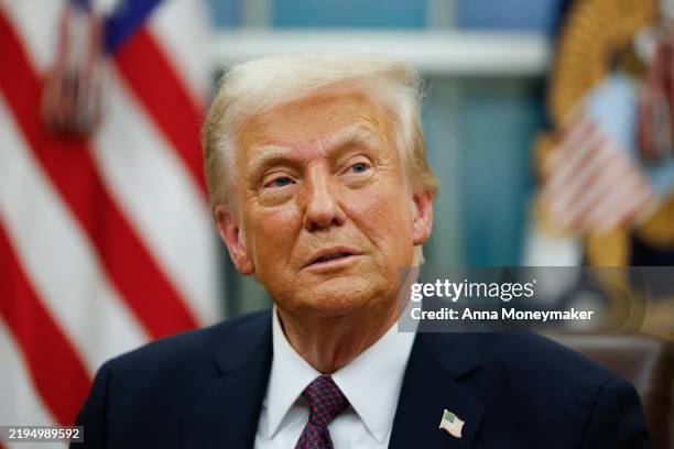 President Donald Trump signs executive orders in the Oval Office on January 20, 2025 in Washington, DC. Trump takes office for his second term as the...