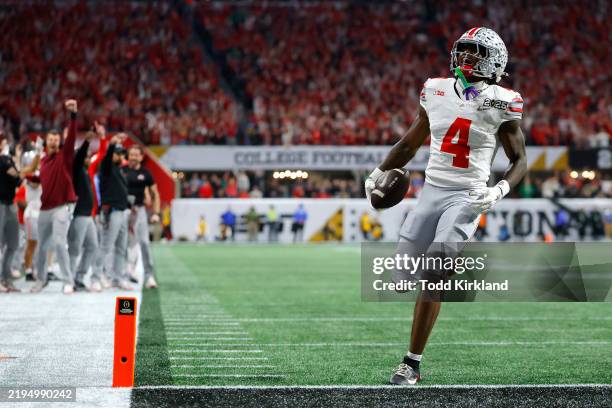 Jeremiah Smith of the Ohio State Buckeyes scores a touchdown against the Notre Dame Fighting Irish during the second quarter in the 2025 CFP National...