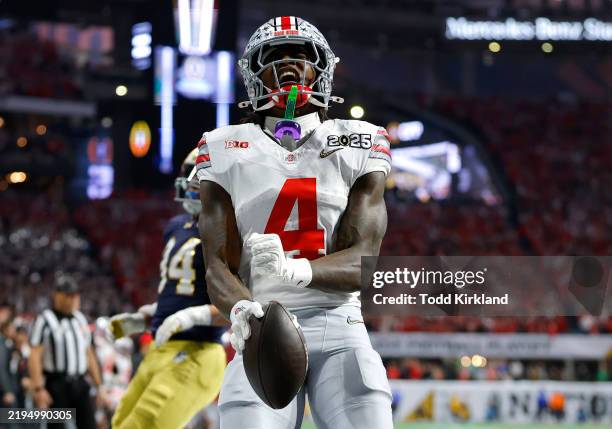 Jeremiah Smith of the Ohio State Buckeyes celebrates after scoring a touchdown against the Notre Dame Fighting Irish during the second quarter in the...