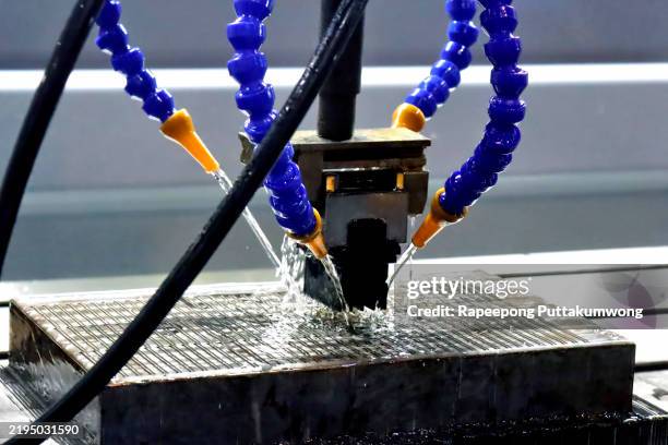 the edm machine working with liquid coolant method. the mold and die manufacturing process by graphite electrode. - edm machine stock pictures, royalty-free photos & images