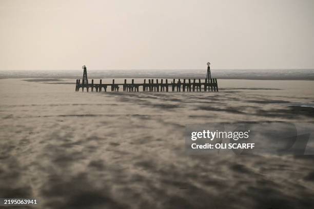 Photograph taken on January 24, 2025 shows blown sands on St Annes beach in Lytham St Annes, near Blackpool, north-west England, as storm Eowyn...