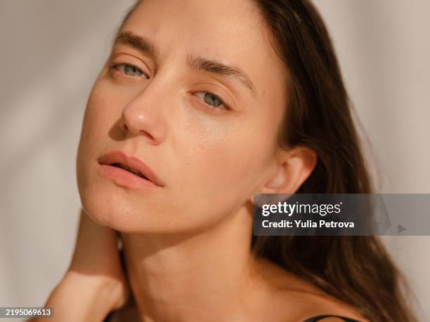 close-up portrait of a woman with clean, moist skin in the sunlight - no make up stock pictures, royalty-free photos & images