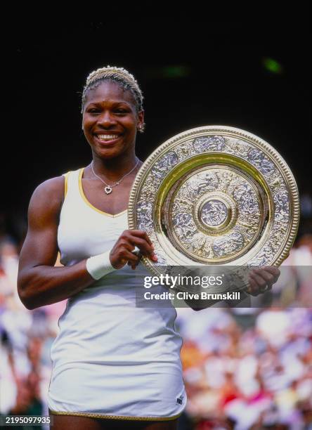 Serena Williams from the United States holds aloft the Venus Rosewater Dish after winning the Women's Singles Final match against her sister Venus...