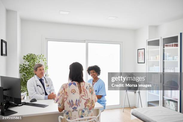 medical experts listening to patient - three nurses stock pictures, royalty-free photos & images