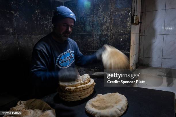 Fresh bread is made in a store in the city of Homs on January 21, 2025 in Homs, Syria. Homs, the country’s third-largest city, has a mixed population...