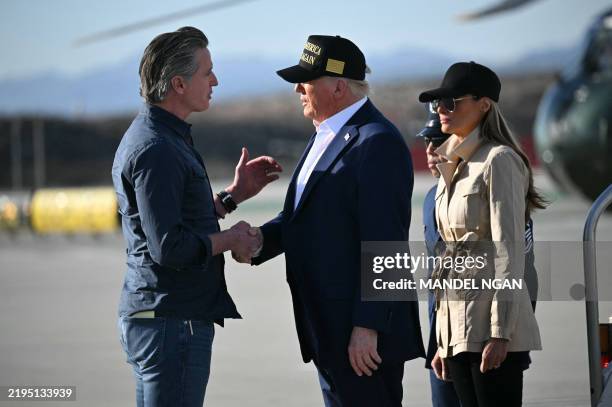 President Donald Trump followed by First Lady Melania Trump, shakes hands with California Governor Gavin Newsom upon arrival at Los Angeles...