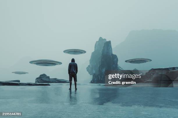 man looking at ufos in fantasy landscape - time machine stock pictures, royalty-free photos & images